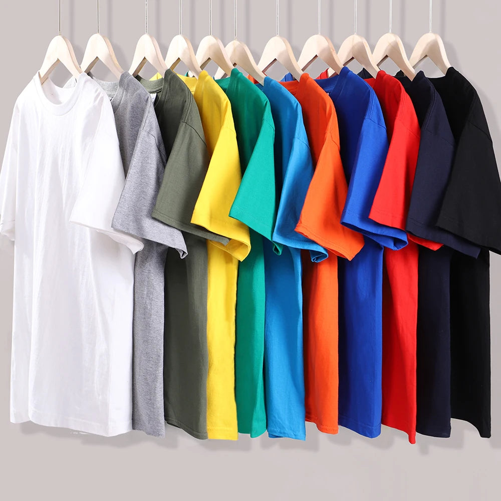 Row of colorful shirts on hangers against a neutral background